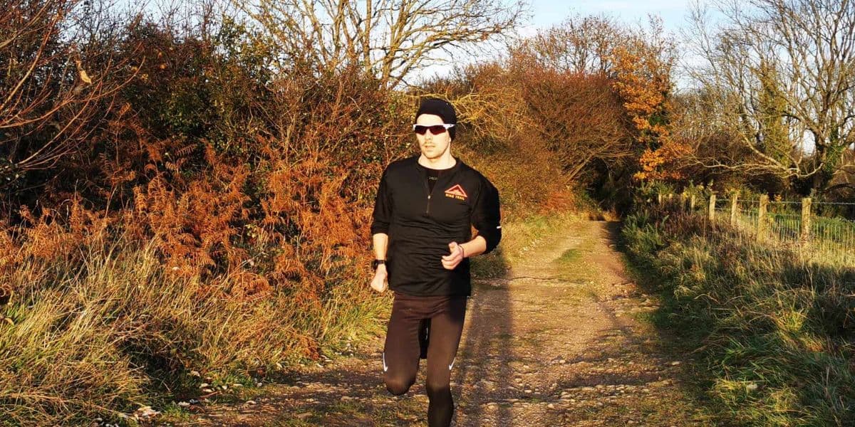 Winter Running  A runner in winter sun on a trail